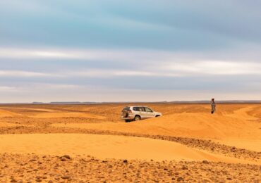 a person standing in the middle of a desert