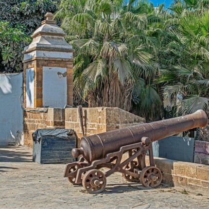 an old cannon sitting on top of a stone wall